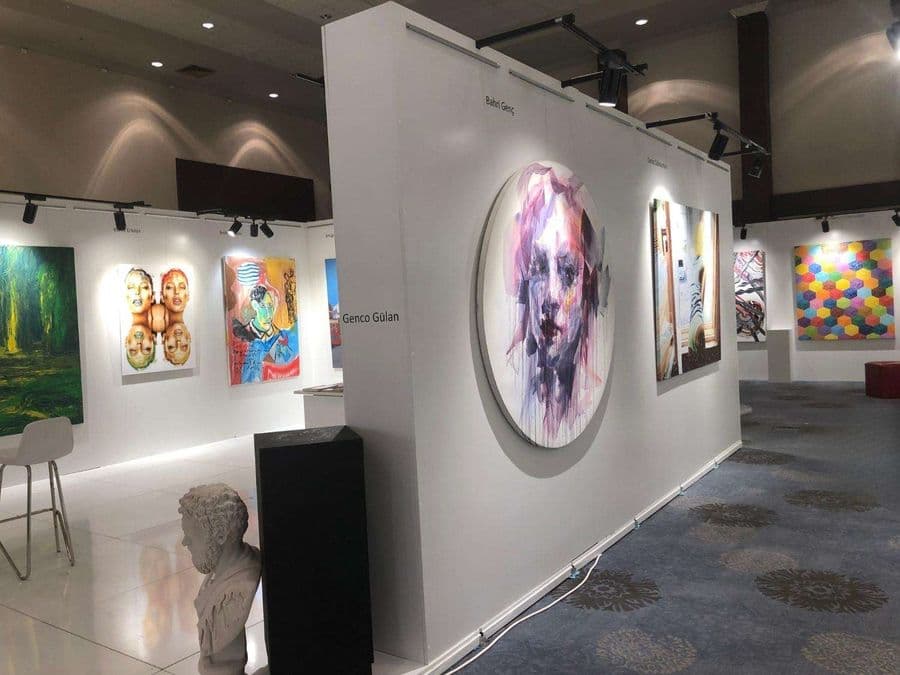 a art gallery with paintings on the wall