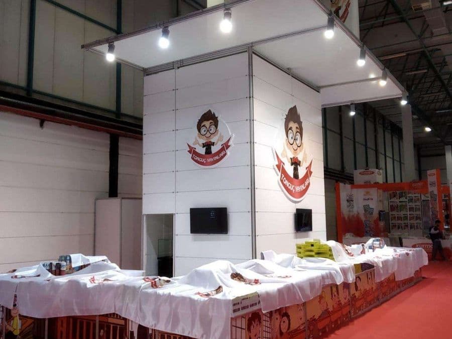 a white booth with white tablecloths and a cartoon character on it